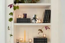 07 a lovely arched niche with shelves displaying books, candles and a potted plant is a stylish idea for a any space