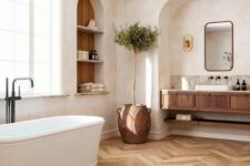 17 a welcoming bathroom with an arched niche and a built-in vanity inside it, an arched niche with storage shelves and an oval tub