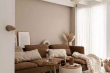 a lovely living room with a greige accent wall