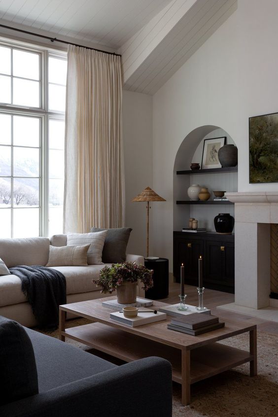 an arched niche with black shelves, vases and artwork, a black built-in cabinet for storage is a great idea