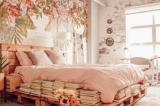 20 an eclectic bedroom with a painted floral wall, a pallet bed with blush bedding, stacks of books and bulbs over the space