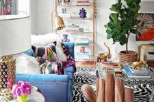 33 a maximalist living room with a blue sofa, a whimsy chair, colorful rugs and pillows and a bold statement plant in a basket
