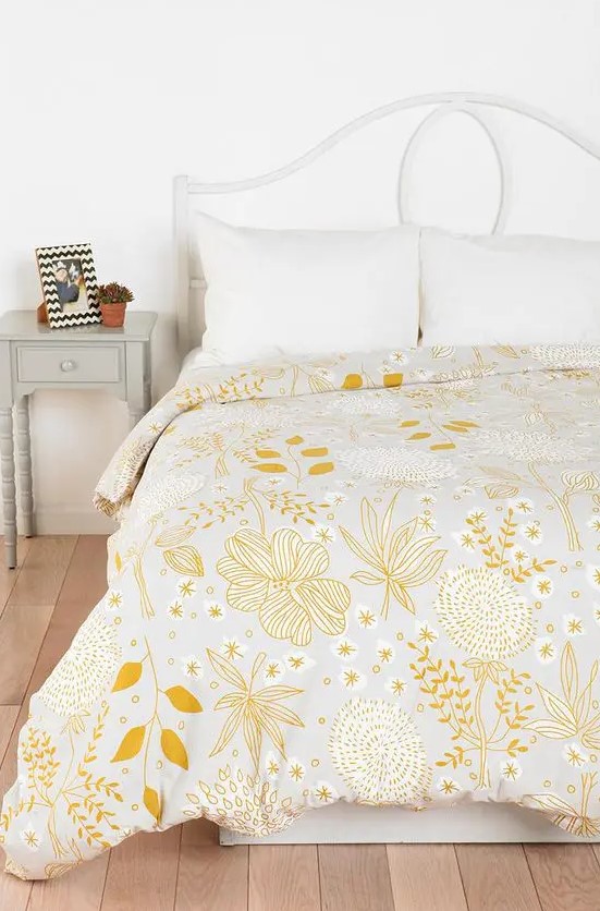 a pretty yellow floral and botanical print blanket is all you need to refresh the space for spring