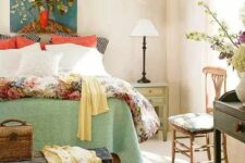 35 a vintage farmhouse with printed wallpaper, printed and colorful bedding, vintage furniture and a bright artwork