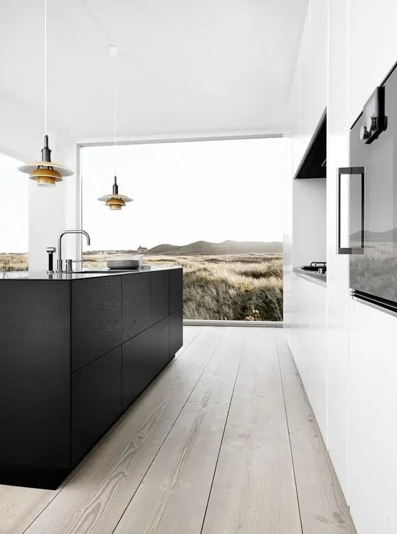 a contemporary kitchen with a niche for cooking, a black kitchen island, a glazed wall and cool pendant lamps over the island