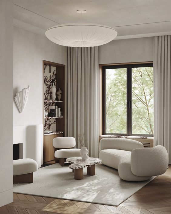 neutral living room with sculptural furniture, a built-in storage niche and neutral textiles