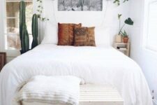52 a small yet airy bedroom with potted cacti and greenery in pots attached to the wall for a fresh feel