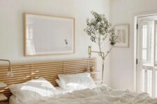 57 a chic Japandi bedroom with a wooden slat headboard, a bed with neutral bedding, lamps and a potted plant