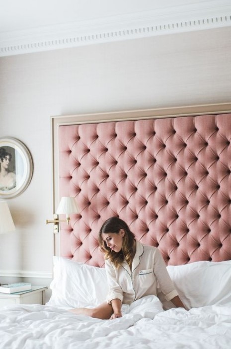 an oversized pink tufted headboard in a frame is a very girlish, cute and elegant idea to try