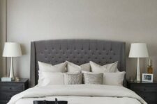 60 an elegant charcoal grey tufted wingback headboard, a crystal chandelier and a leather bench make up a glam modern space