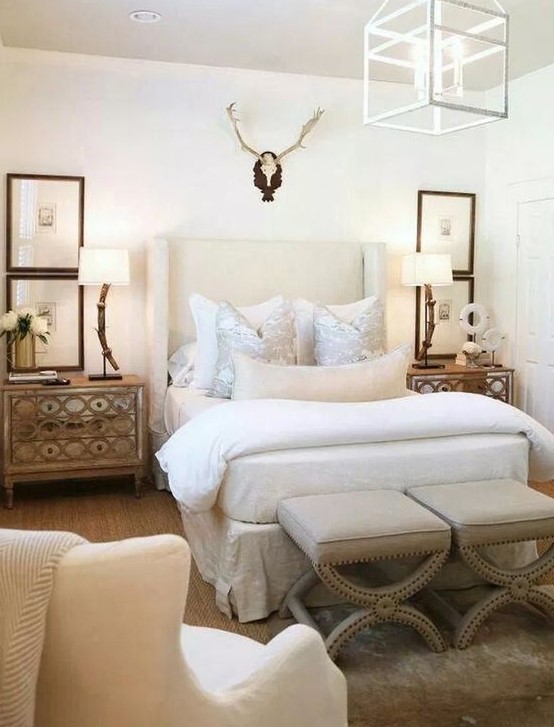 a soft creamy upholstered wingback headboard and matching refined stools for a bold elcectic bedroom