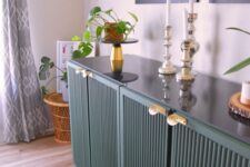 66 a dark green IKEA Ivar hack with fluted doors and gold handles is a very chic and sophisticated idea