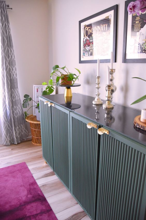 a dark green IKEA Ivar hack with fluted doors and gold handles is a very chic and sophisticated idea