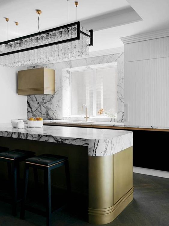 a beautiful contemporary kitchen with black and white cabinets, a curved kitchen island, white marble countertops and a backsplash