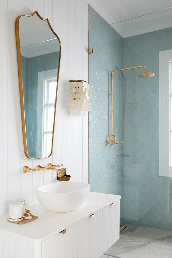 ديكورات حمامات حديثة A-beautiful-neutral-and-light-blue-bathroom-with-a-white-floating-vanity-brass-fixtures-and-a-cool-mirror