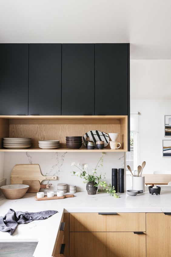 a black and light-stained kitchen with white quartz countertops and a backsplash is a lovely and chic contemporary space
