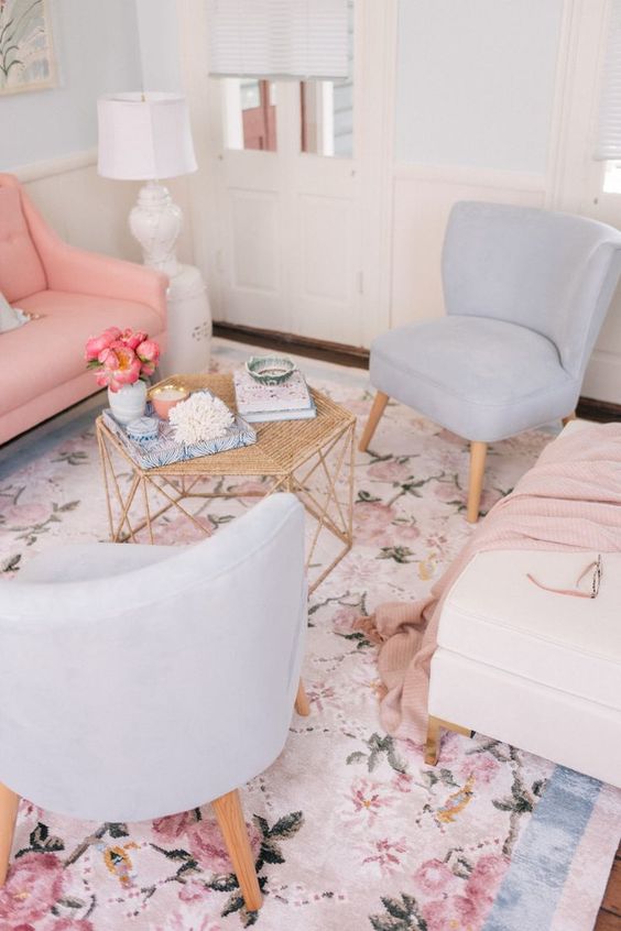  غرف معيشة بألوان الباستيل  A-delicate-living-room-with-a-pink-sofa-pale-blue-chairs-a-pastel-floral-print-rug-a-hexagon-table-with-decor
