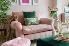 a fab living room with blush walls, a blush chair and a pink pouf, a green ottoman and a gallery wall, potted plants and blooms