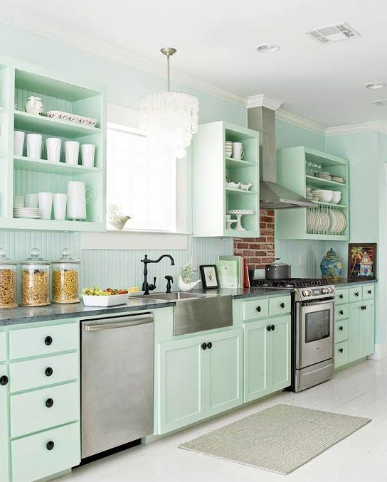 a fresh and beautiful mint green kitchen with black knobs, fixtures and much white to make it look more ethereal