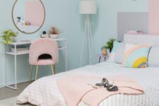 a fun pastel bedroom with blue walls, a low bed with pastel bedding, a console table and a pink chair, a pastel rug