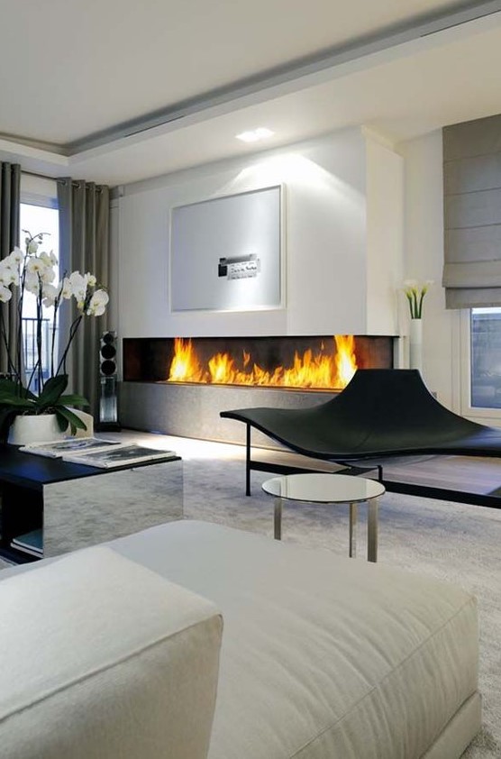 a large minimalist built-in fireplace in the living room is a stylish and bold idea with a modern feel