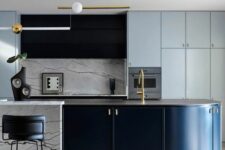 a light blue kitchen with a black hood, a curved black and white kitchen island, a white marble backsplash and countertops