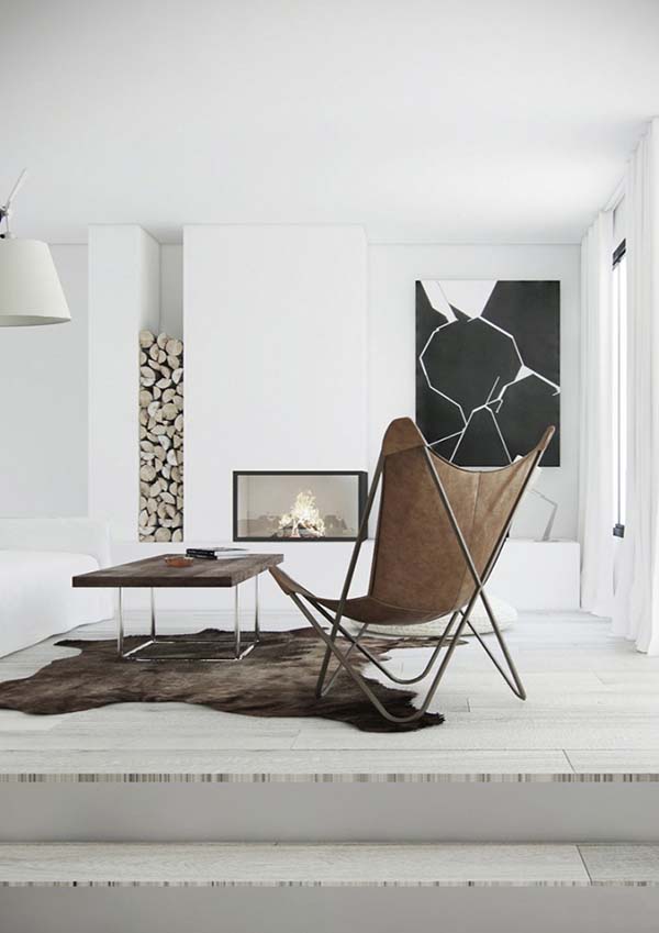 a minimal space with a built in fireplace, firewood, a black and white artwork, a stained table and a leather butterfly chair