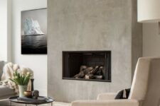 a minimalist fireplace built-in seamlessly into the concrete wall is a chic idea to add eye-catchiness