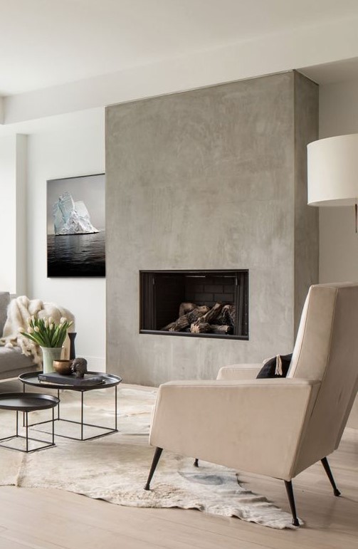 a minimalist fireplace built-in seamlessly into the concrete wall is a chic idea to add eye-catchiness