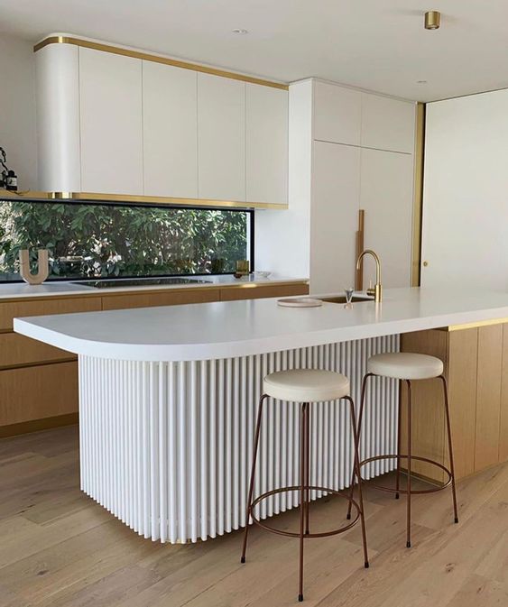 a minimalist kitchen with sleek curved cabinets, stained ones, a window backsplash, a curved fluted kitchen island and tall stools