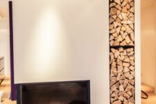 a minimalist white fireplace with a built-in niche for storing firewood is a cool idea for a contemporary or minimalist space