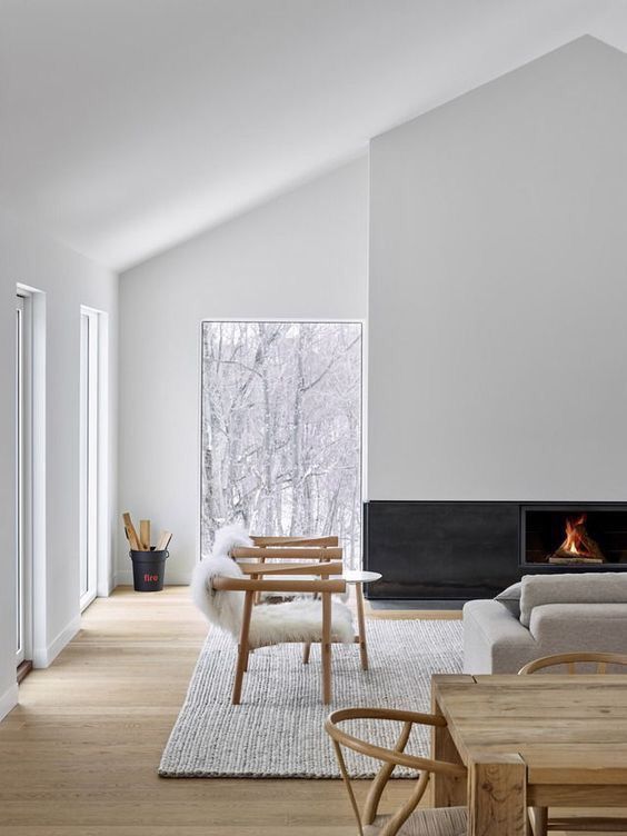 a neutral living room with a minimalist fireplace built in, a neutral chairs and a sofa, a dining space here