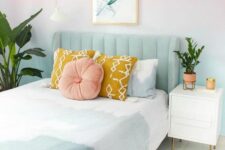 a pastel bedroom with gradient walls, a mint green bed with pastel bedding, a nightstand and some potted greenery