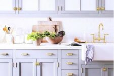 a romantic lilac kitchen with a white subway tile backsplash and a white countertop plus gold touches