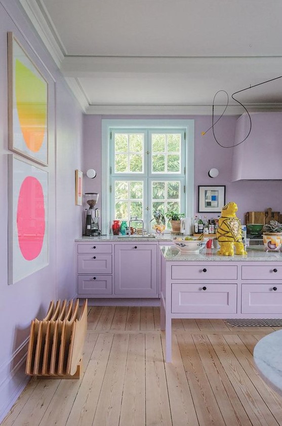 a tender lilac kitchen with bright abstract artworks is a very girlish and welcoming space