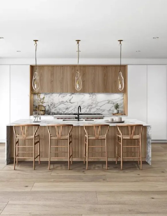 a white minimalist kitchen with fluted upper cabinets, a white marble backsplash, a fluted kitchen island with a white marble countertops and tall stools