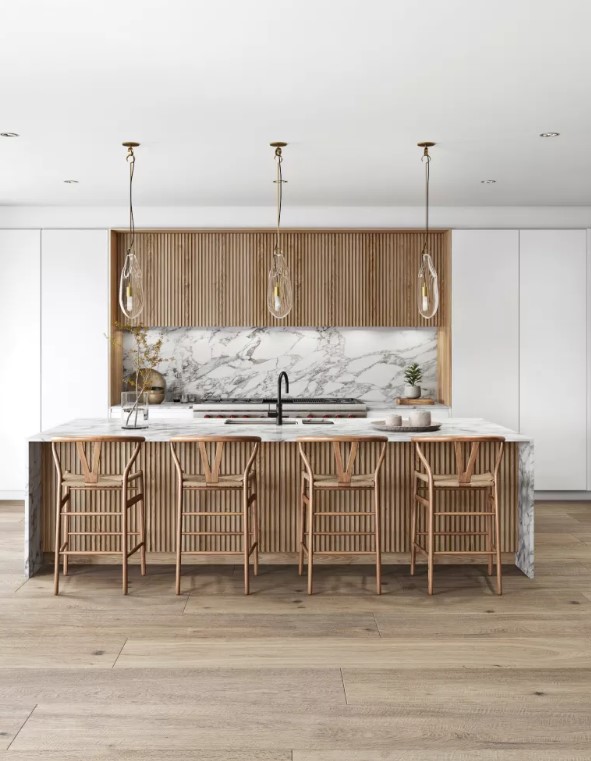 a white minimalist kitchen with fluted upper cabinets, a white marble backsplash, a fluted kitchen island with a white marble countertops and tall stools