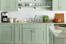 02 a beautiful farmhouse kitchen in mint green, with shaker cabinets, open shelves, white subway tiles and vintage fixtures