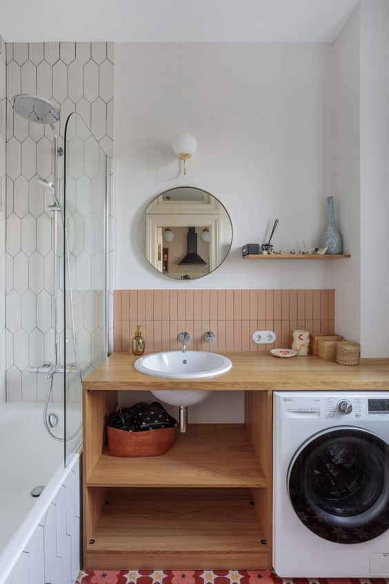 a small modern bathroom with a vanity and a built in washing