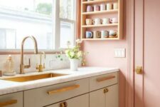 05 a beautiful Scandinavian kitchen with pink walls and grey cabinets, brass fixtures and a brass sink