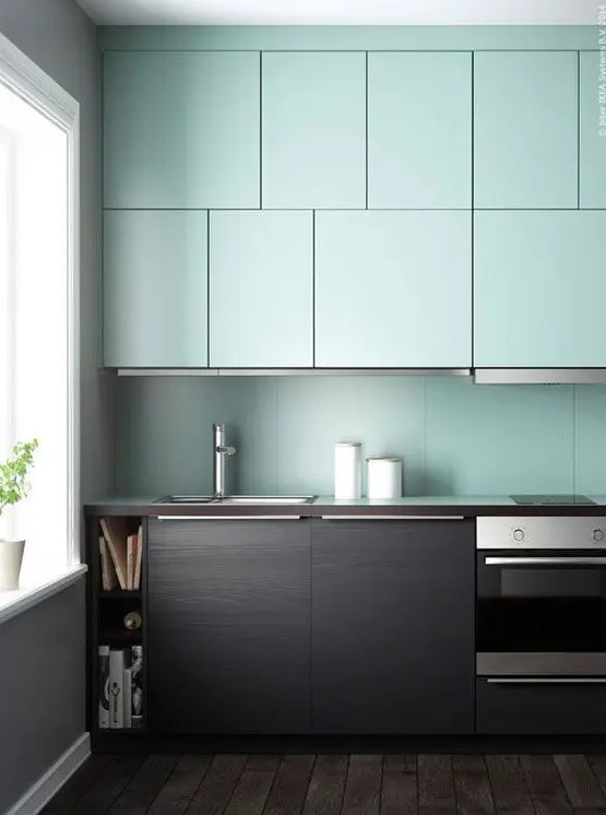 a dark stained wood and mint kitchen with a mint backsplash looks very contrasting and unusual