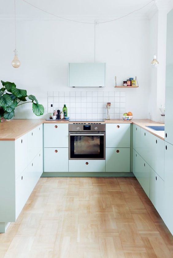 https://www.digsdigs.com/photos/2023/02/08-a-lovely-mint-blue-Scandinavian-kitchen-with-plywood-cabinets-butcherblock-countertops-a-square-tile-backsplash-and-pendant-bulbs.jpg