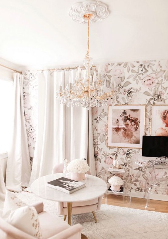 a neutral living room with floral wallpaper, neutral seating furniture, neutral curtaons and clear Lucite furniture