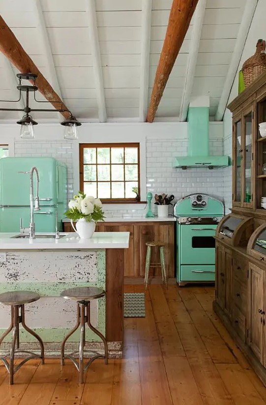 a mint fridge, a cooker and a hood give this rustic kitchen a retro feel and make it look bolder and fresher