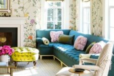 10 a pretty and chic living room with bright floral wallpaper, a navy sectional, a striped chair, a non-working fireplace, a bold neon yellow ottoman