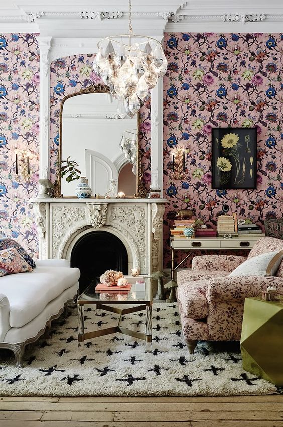 غرف معيشة بطبعات الزهور 12-a-sophisticated-living-room-with-pink-floral-wallpaper-a-creamy-sofa-a-pink-floral-chair-a-coffee-table-a-fireplace-and-a-chandelier