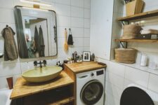 14 a small white bathroom clad with white tiles, with wooden shelves and an open timber vanity plus a built-in washing machine