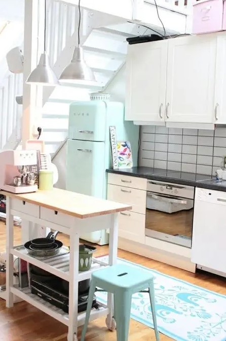 a mint Smeg fridge and a matching stool for a small and cozy neutral kitchen