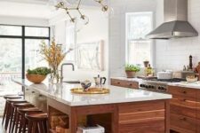 18 a welcoming mid-century modern walnut kitchen with stylish cabinets and a large kitchen island, white stone countertops and a catchy chandelier