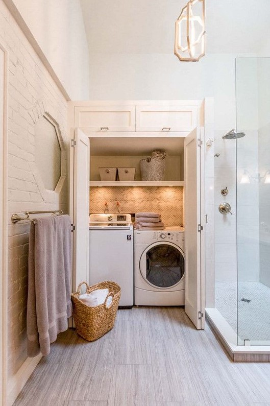 a small laundry hidden right in the bathroom, with built-in lights and folding doors is a very comfortable solution
